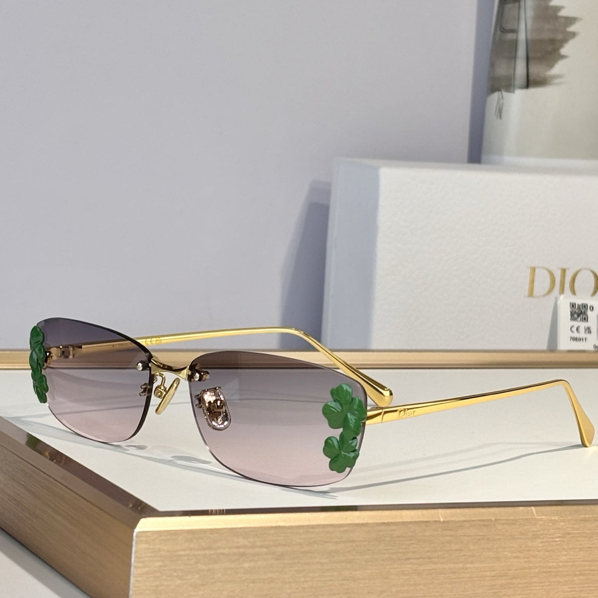 D**R Slim Rimless Oval Sunglasses with Warm Brown Solid Lenses, Silver Metal Temples & Sculptural White Flower Cluster Embellishment