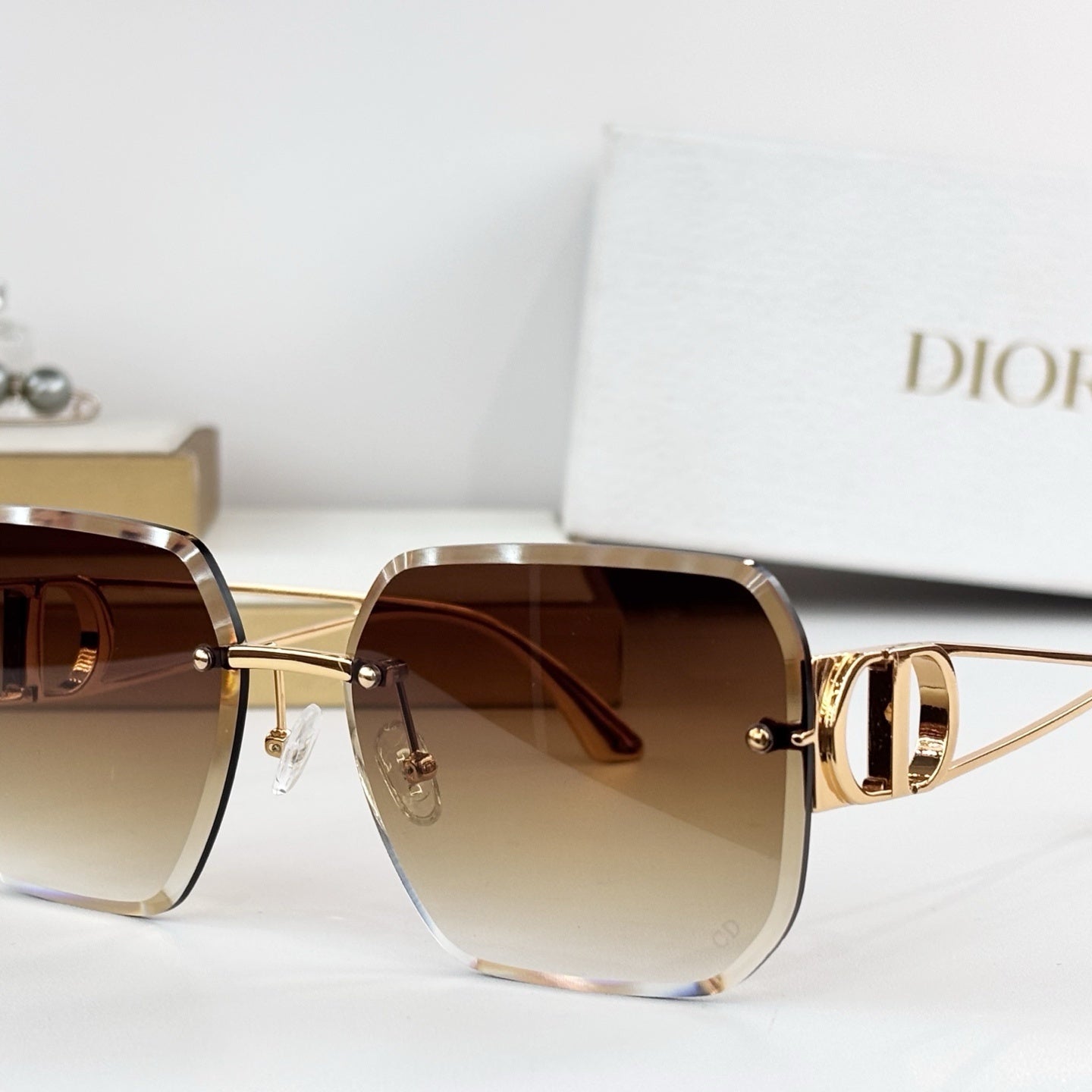 D**R 30Montaigne S6U Rimless Sunglasses | Gold Metal Frame, Brown Gradient Bevelled Lenses, CD Logo Temple | Multiple Colors