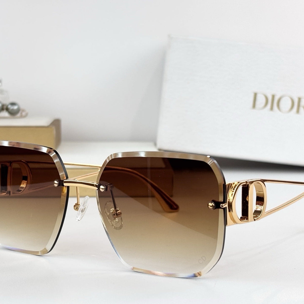 D**R 30Montaigne S6U Rimless Sunglasses | Gold Metal Frame, Brown Gradient Bevelled Lenses, CD Logo Temple | Multiple Colors