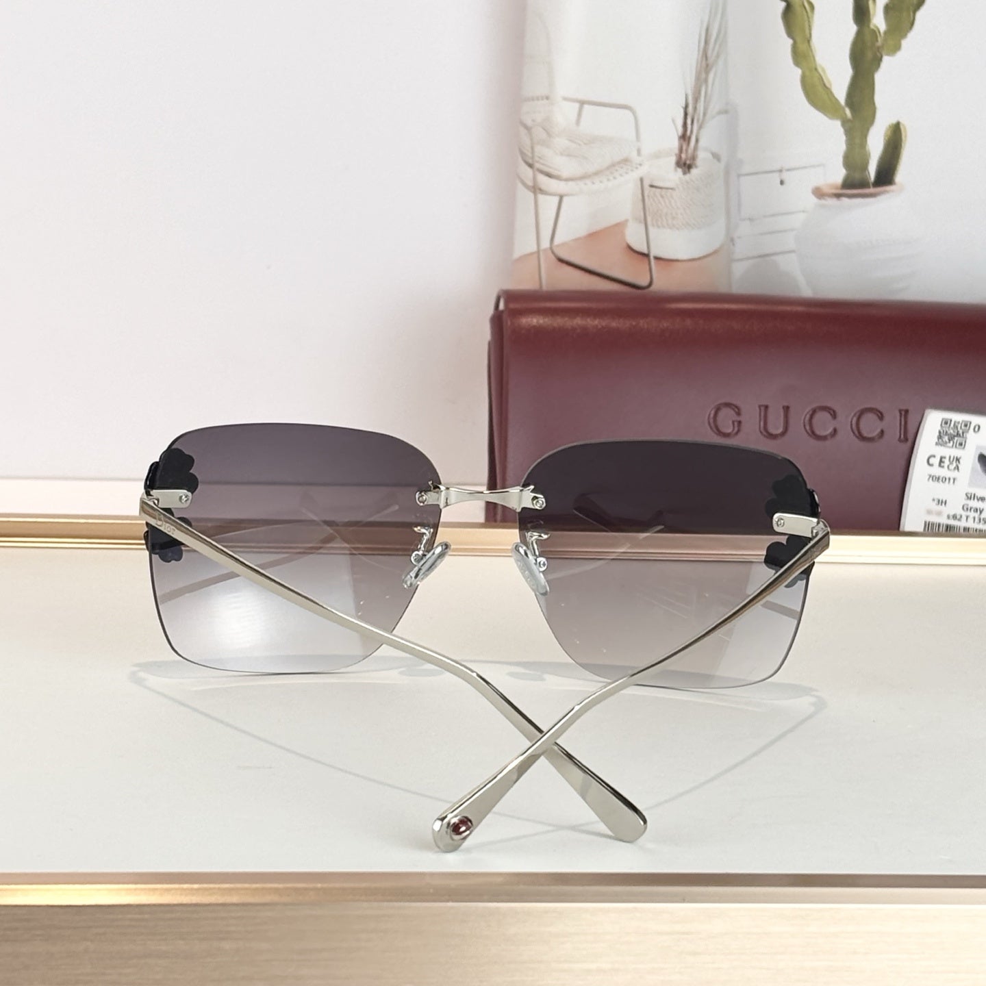 D**R Oversized Rimless Butterfly Sunglasses with Grey Gradient Lens, Silver Temples & Sculptural Black Flower Cluster Embellishment