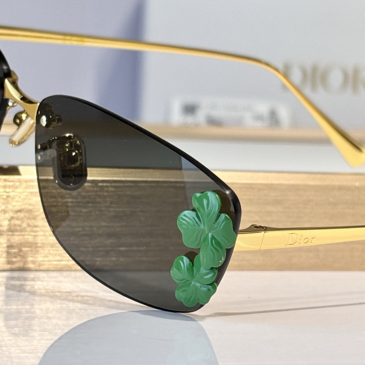 D**R Slim Rimless Rectangular Sunglasses with Dark Green Solid Lenses, Gold Metal Temples & Emerald Green Flower Cluster Embellishment