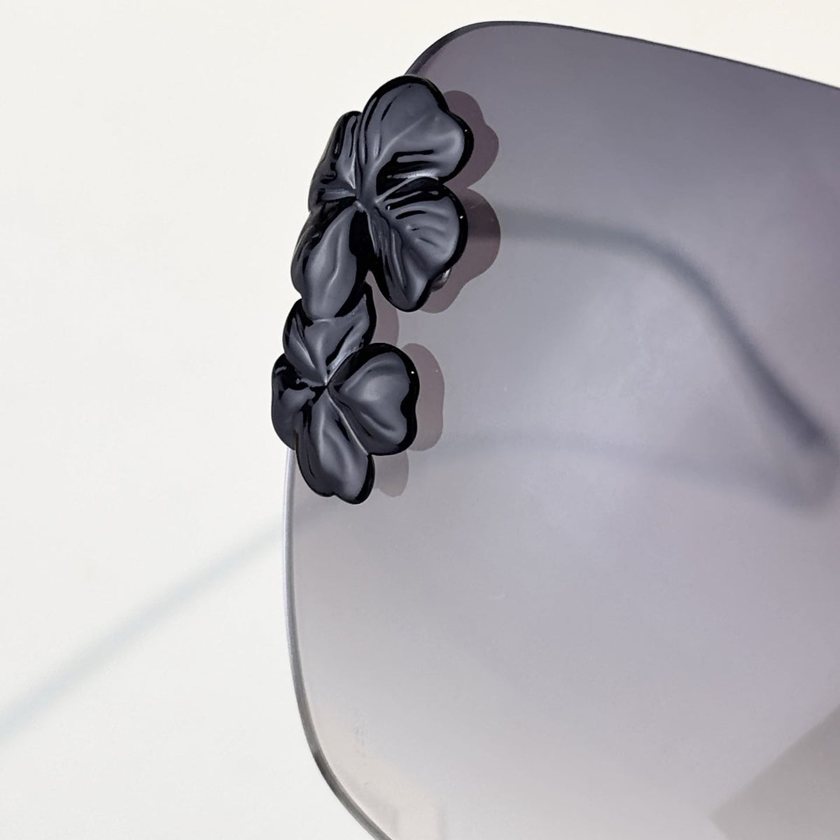 D**R Oversized Rimless Butterfly Sunglasses with Grey Gradient Lens, Silver Temples & Sculptural Black Flower Cluster Embellishment