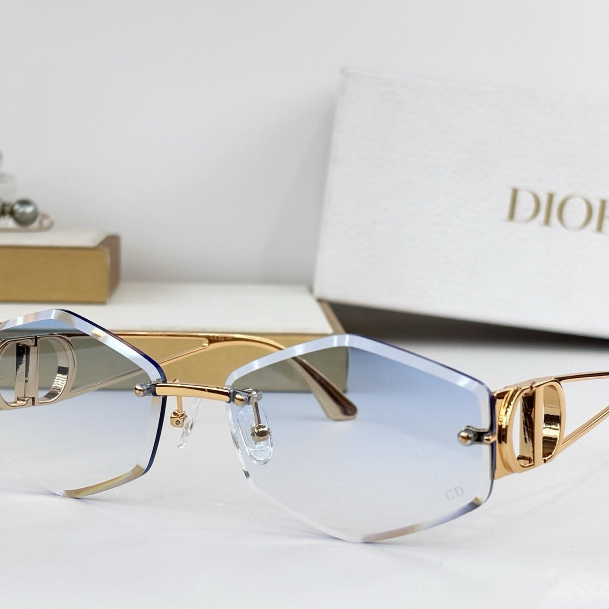 D**R 30Montaigne S6U Rimless Sunglasses | Gold Metal Frame, Brown Gradient Bevelled Lenses, CD Logo Temple | Multiple Colors