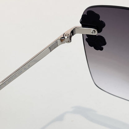D**R Oversized Rimless Butterfly Sunglasses with Grey Gradient Lens, Silver Temples & Sculptural Black Flower Cluster Embellishment