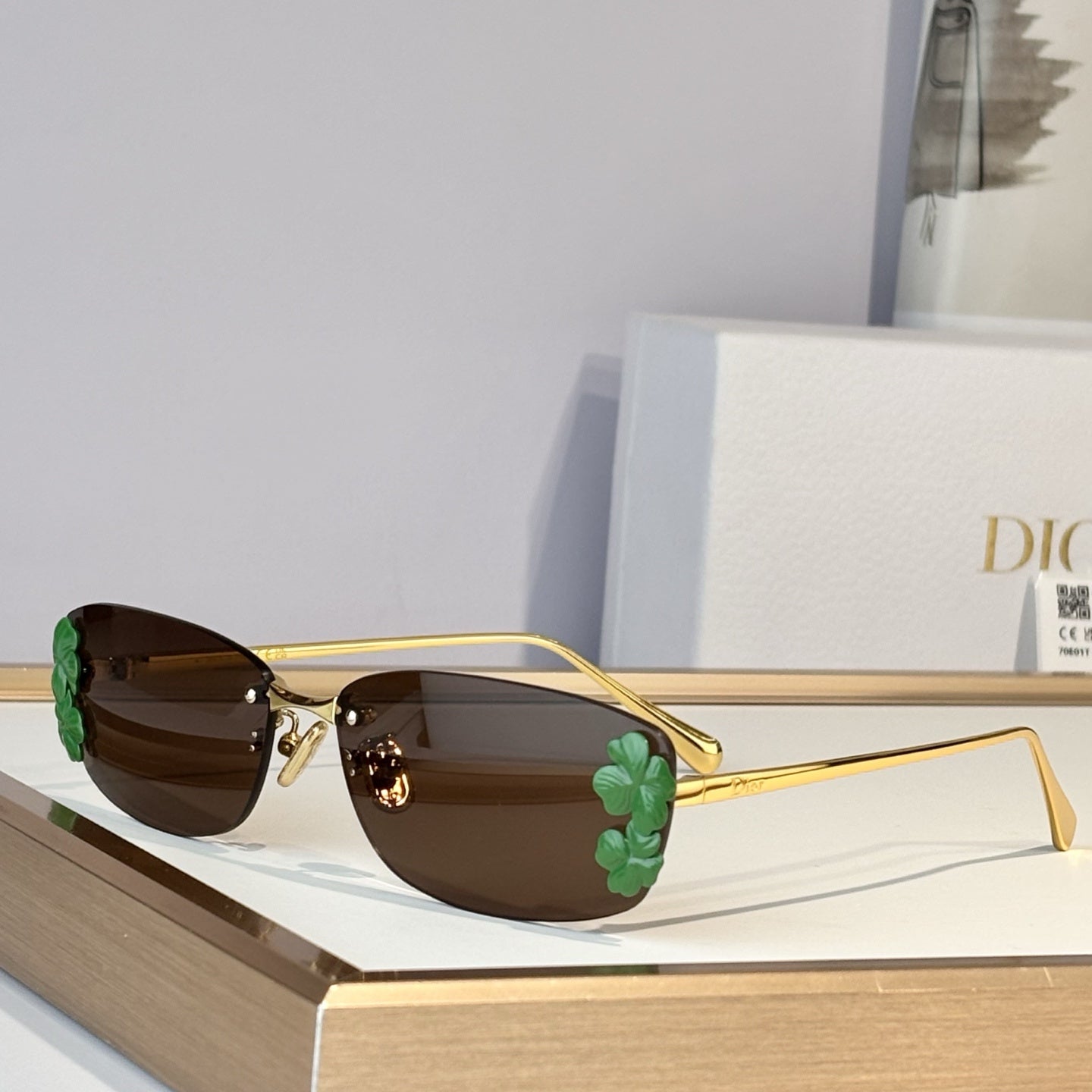 D**R Slim Rimless Oval Sunglasses with Warm Brown Solid Lenses, Silver Metal Temples & Sculptural White Flower Cluster Embellishment
