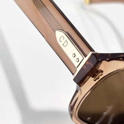 D**R Bold Square Acetate Sunglasses | Transparent Champagne-Brown Frame, Gold CD Metal Inlay, Three-Rivet Temple, Flat Brown Lenses