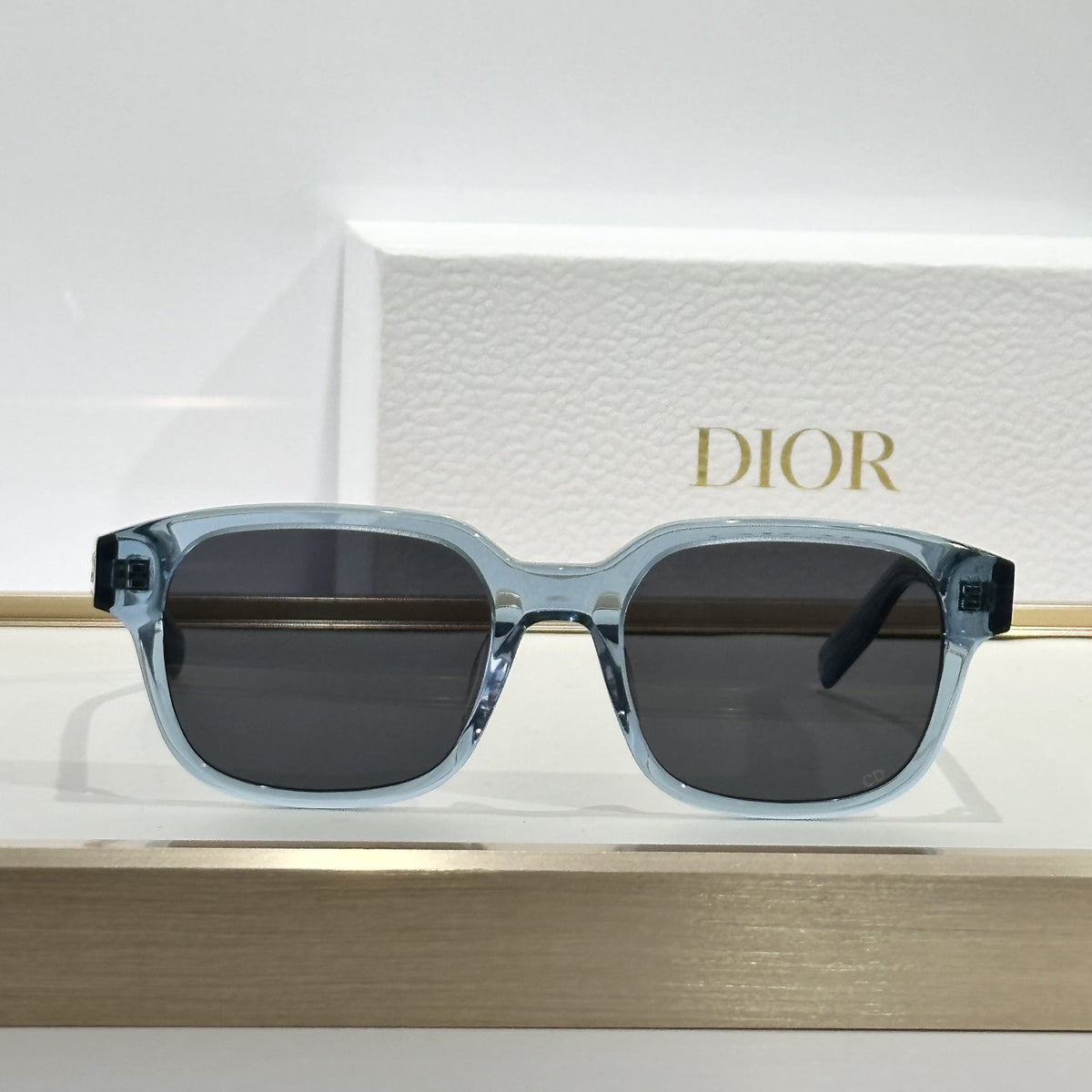 D**R Square Sunglasses | Ice Blue Transparent Frame, Dark Grey Lenses & Black CD Logo Hinge