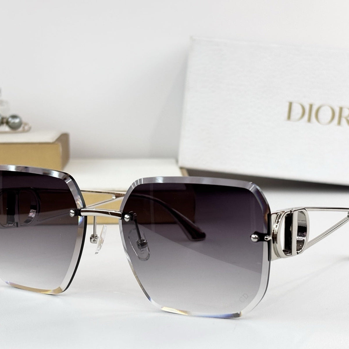 D**R 30Montaigne S6U Rimless Sunglasses | Gold Metal Frame, Brown Gradient Bevelled Lenses, CD Logo Temple | Multiple Colors