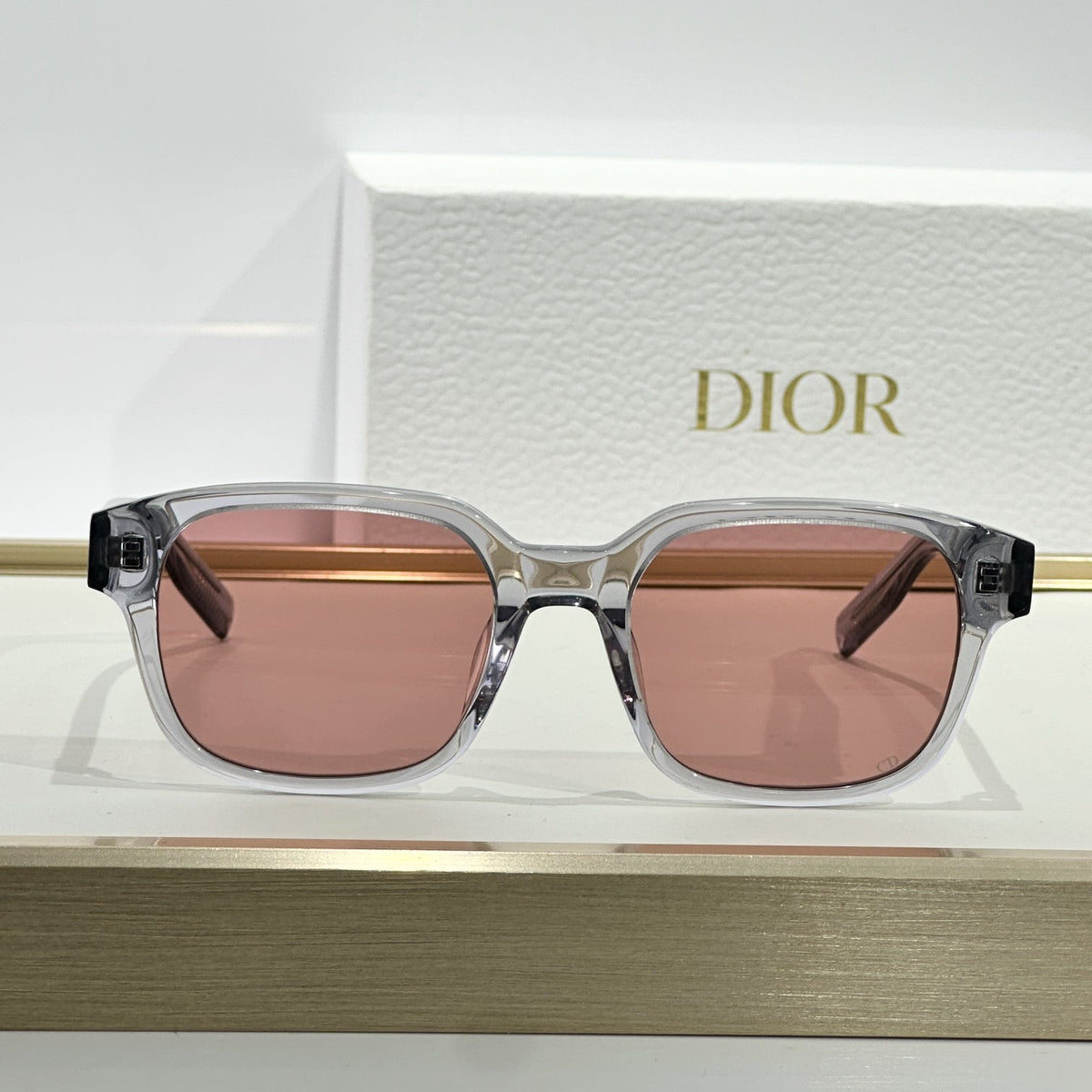 D**R Square Sunglasses | Crystal Grey Transparent Frame, Rose Pink Lenses & Black CD Logo Hinge