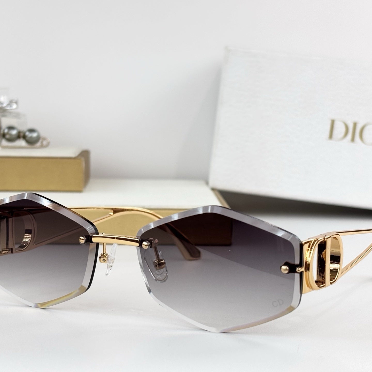 D**R 30Montaigne S6U Rimless Sunglasses | Gold Metal Frame, Brown Gradient Bevelled Lenses, CD Logo Temple | Multiple Colors